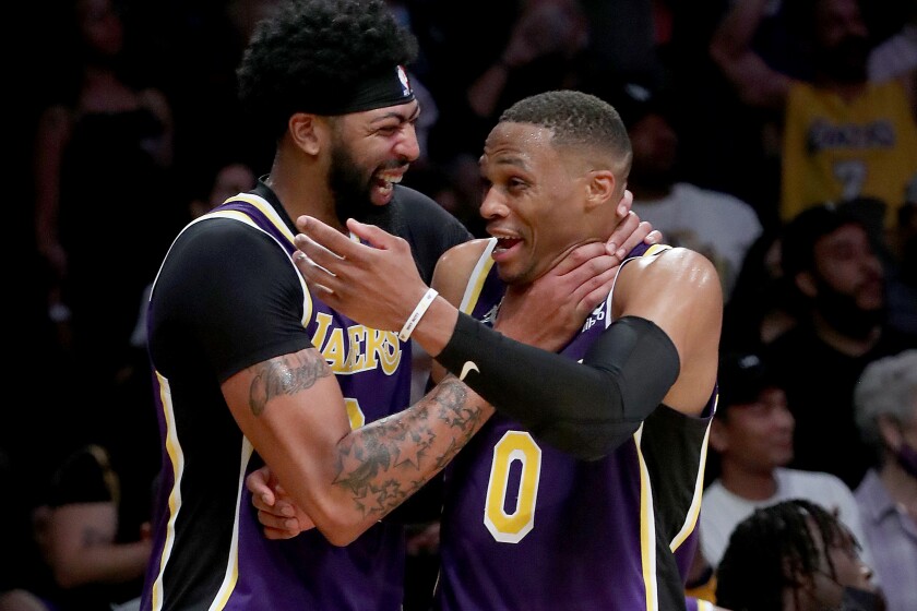 LOS ANGELES, CALIF. - OCT. 29, 2021. Lakers Anthony Davis, left, and Russell Westbrook celebrate a victory.